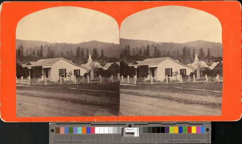 Stereo of a small house with church behind, wooded hills in background. Possibly Eugene. [b001] [161] show page link